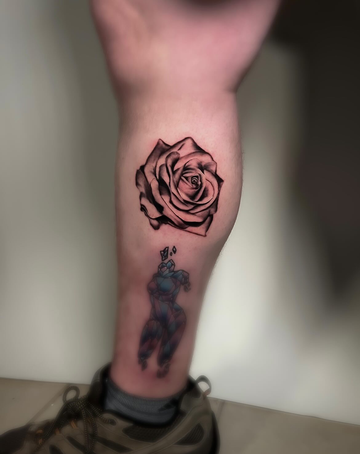 Fine line rose tattoo on a calf by tattoo artist Alessandra Clivio.